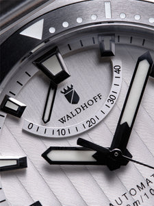 Silver dive watch closeup on power reserve hand