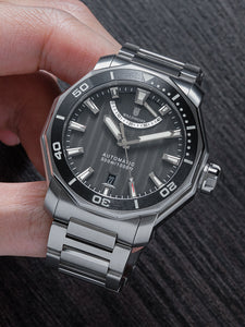 Black dive watch on steel bracelet