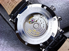Multifunction automatic watch caseback