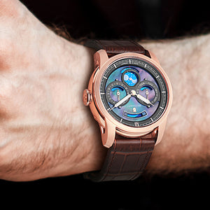 Rose Gold multifunction watch with pearl dial worn by a man